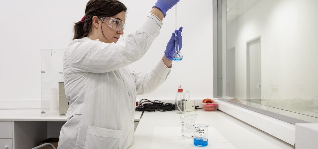 image of a woman mixing drugs for the drug formulation process